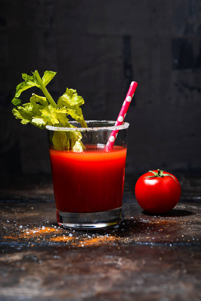 glass of alcoholic cocktail bloody mary on dark background, vertical closeup - Photo, image