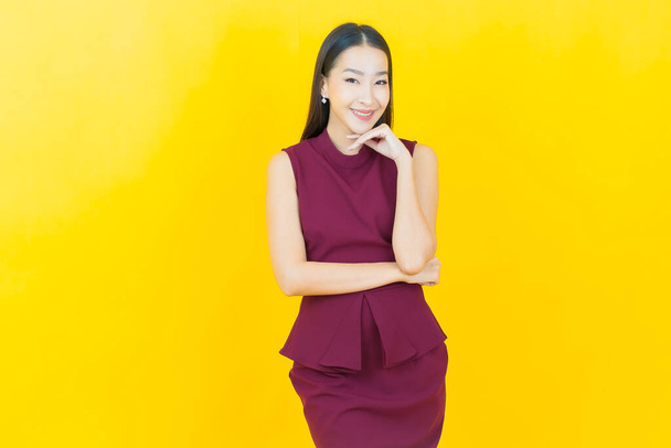 Portrait beautiful young asian woman smile with action on color background - Photo, image