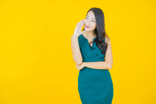 Portrait beautiful young asian woman smile with action on color background - Фото, изображение