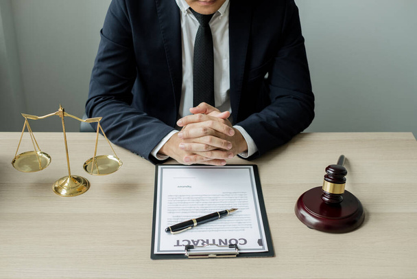 Professional man lawyers work at a law office There are scales, Scales of justice, judges gavel, and litigation documents. Concepts of law and justice. - Photo, Image