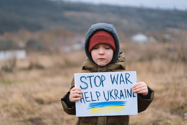 War of Russia against Ukraine. Crying boy asks to stop the war in Ukraine. - Φωτογραφία, εικόνα