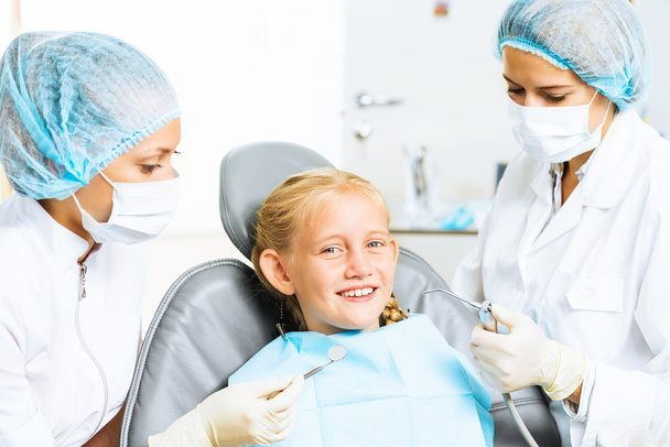 Dentist inspecting patient - Фото, изображение
