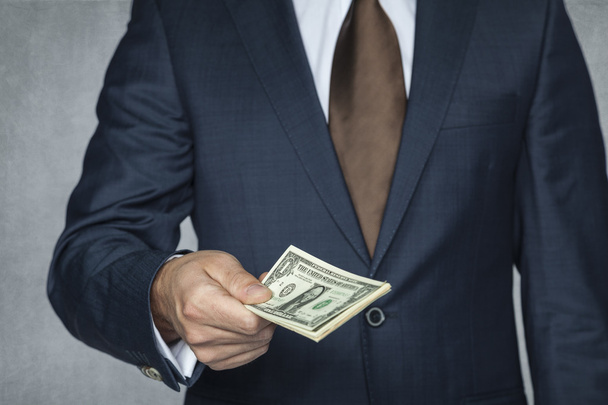 Businessman gives money - Фото, изображение