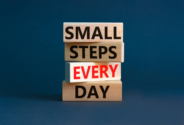 Small steps every day symbol. Concept words Small steps every day on wooden blocks. Beautiful grey table grey background. Small steps every day business concept. Copy space. - Foto, afbeelding