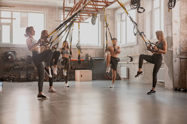 Athletic people doing crossfit training in gym - Foto, Bild