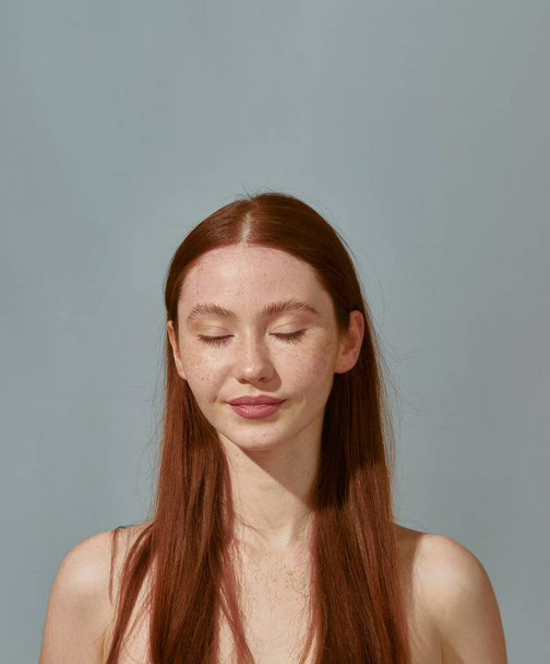Redhead young pretty girl with bare shoulders, long hair closed eyes enjoying healthy pure healthy skin. Natural beauty - Photo, Image