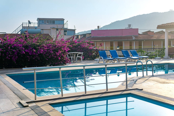 Yüzme havuzlu ve güneşli boş bir otel. - Fotoğraf, Görsel