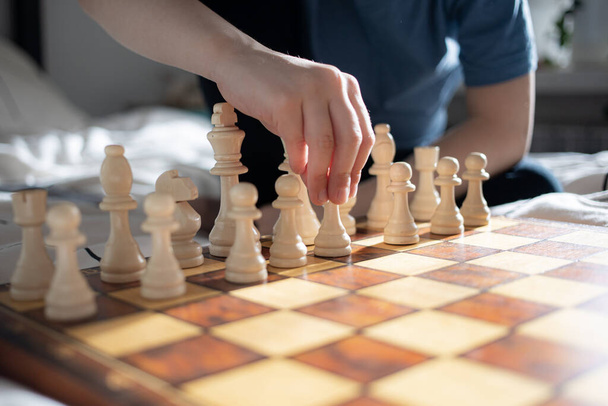 Close up of kids hand playing chess - Foto, imagen