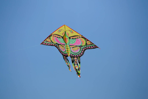 Blue sky with sun and a kite, the childhood symbol. - Фото, зображення