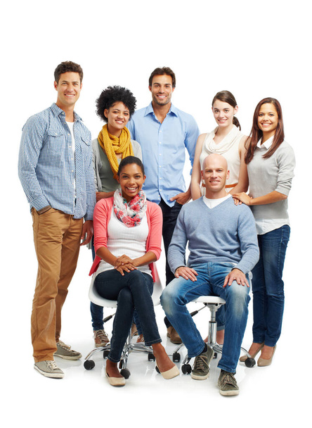 Theyre a smiling group. Smiling group of casual young adults together against a white background. - Photo, Image