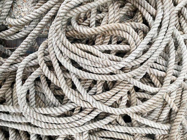 Premium Photo  Braided thick rope tied in a skein. hemp rope for  decoration and design. background from a fishing rope.