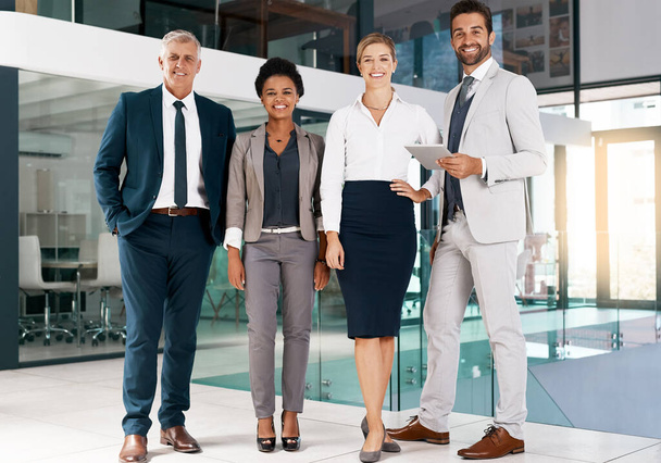 We always bring our A-game. Portrait of a group of businesspeople standing together in an office. - Foto, Imagen