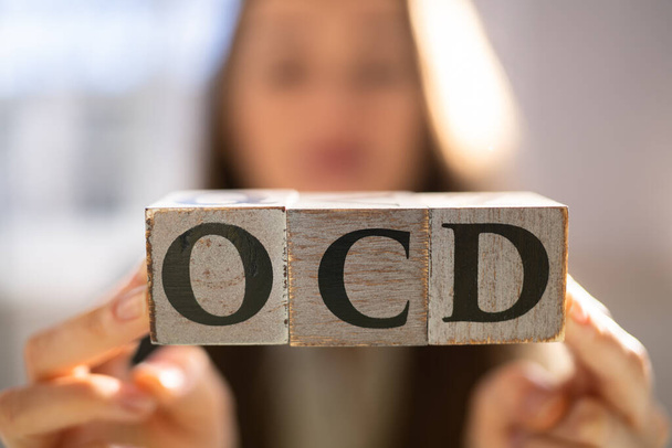 OCD Perfectionist Obsession. Perfectionist With Wooden Blocks - 写真・画像