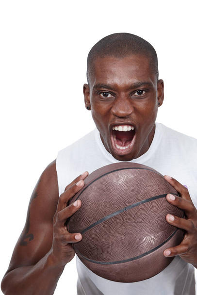 Its game on. Studio shot of a determined young basketball player shouting while holding a basketball. - Foto, imagen