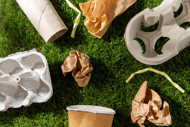 close up of paper waste on grass - Foto, Imagem