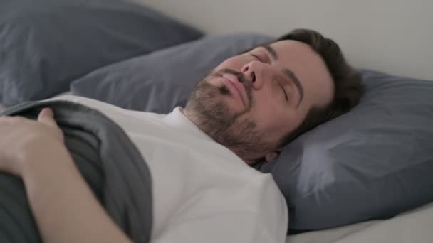 Giovane uomo dormire a letto pacificamente - Filmati, video