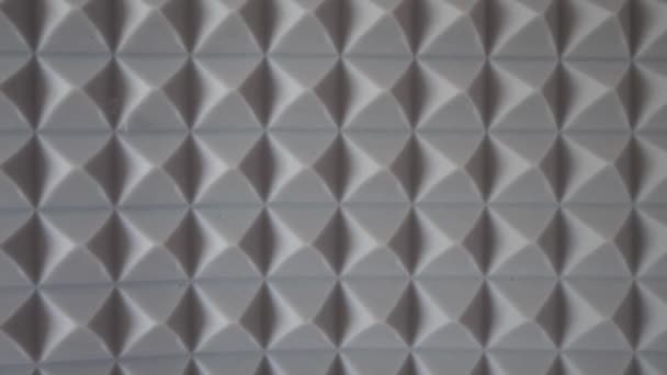 Pyramids of soundproof foam close-up. Noise suppression tool. Gray acoustic foam. Acoustic foam is an open celled foam used for acoustic treatment. It attenuates airborne sound waves. - Footage, Video