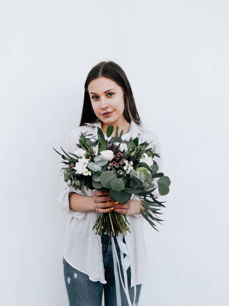 Happy florist girl with a bouquet of flowers - 写真・画像