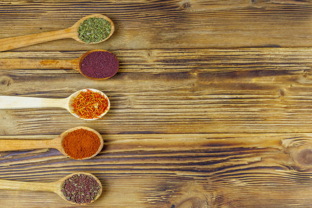 Set of different aromatic spices on wooden table. Top view, copy space - Photo, Image
