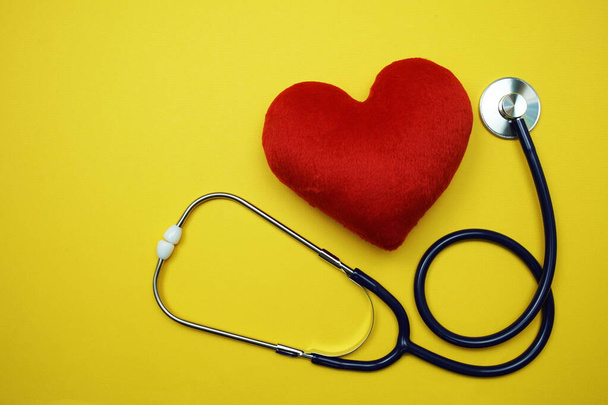 Heart and Stethoscope with space copy on yellow background - Foto, afbeelding