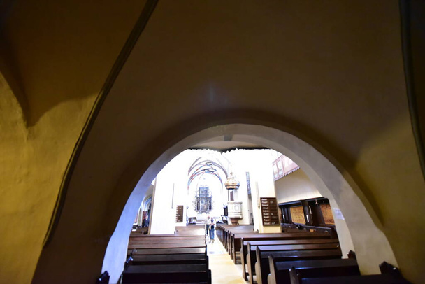 inside the catholic church from Sighisoara with organ, arches, roman rosettes, bell tower with statues with Christ and Romanian soldiers in a catholic ambiance as important as military architecture - 写真・画像