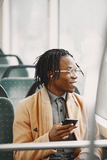 Young African businessman sitting in a bus - Zdjęcie, obraz
