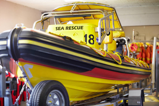 The life guards trusty vessel. Cropped shot of a sea rescue boat inside a lifeguard station. - Photo, Image