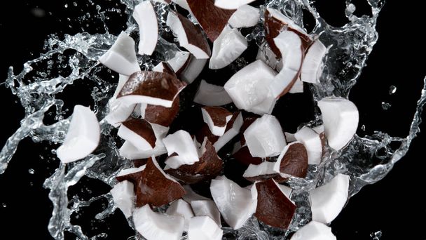 Freeze motion of coconuts in water splash. Isolated on Black Background. - Valokuva, kuva