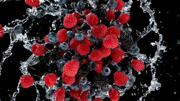 Freeze motion of berries in water splash. Isolated on Black Background. - Foto, afbeelding