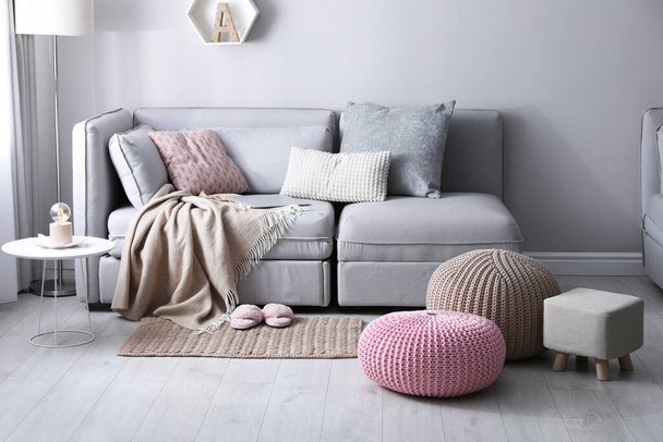 Stylish poufs and ottoman near sofa in living room. Interior element - Foto, Imagen