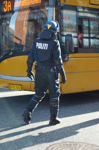 Crowd control. Rearview shot of a police man in riot gear. - Fotografie, Obrázek
