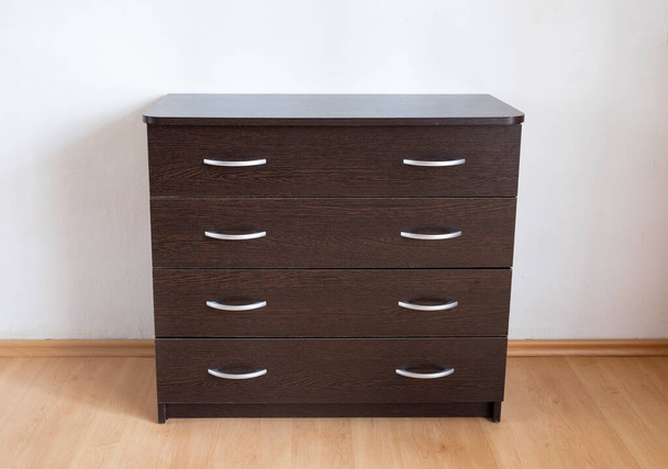 Chest of drawers with four drawers and metal handles. Step-by-step instructions for assembling a chest of drawers dark wood - Photo, Image