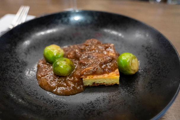 Spanish tasting menu, tapas potato tortilla with meat sauce and brussels sprouts - Photo, Image