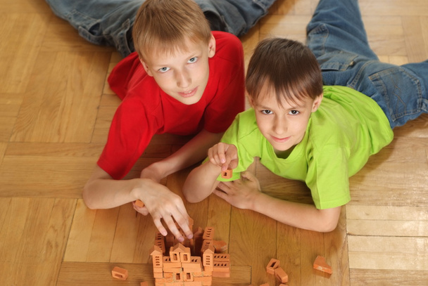 Brothers are building on the floor - Photo, Image