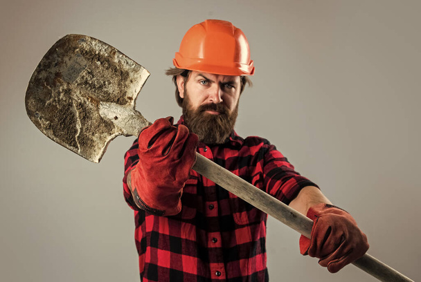 handsome bearded guy with beard and moustache hold shovel, laborer - Foto, Imagen