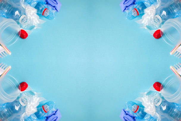 Top view of various kinds of disposable plastic waste on blue background, copy space. - Foto, Imagem