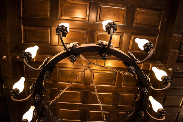 Old chandelier hanging from ceiling. - Foto, Bild