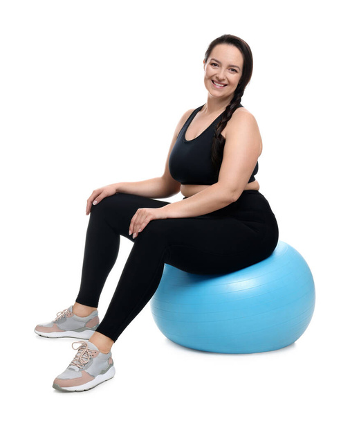 Happy overweight woman sitting on fitness ball against white background - Zdjęcie, obraz