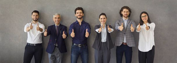 Banner with a team of happy successful business people doing a thumbs up gesture - Foto, Bild