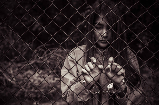 Portrait of women desperate to catch the iron prison,prisoner concept,thailand people,Hope to be free,If the violate the law would be arrested and jailed. - Foto, Bild