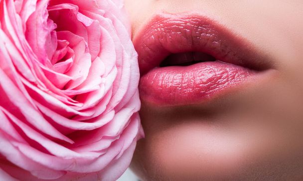 Lips with lipstick closeup. Closeup sexy woman natural lips and pink rose. Beautiful woman lips with rose. - Fotografie, Obrázek