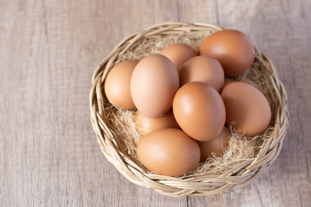 fresh chicken eggs in a wicker basket - 写真・画像
