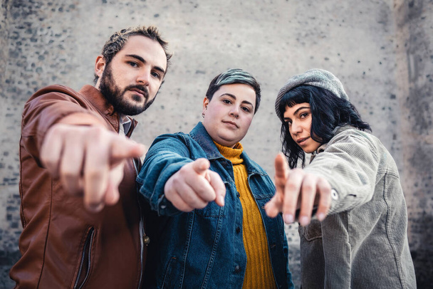 Group of friends pointing of you. Male, non binary and female group of people pointing index finger and looking at the camera - Photo, Image