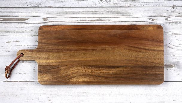 Wooden cutting board on wooden table. Top view copy space. - Photo, Image