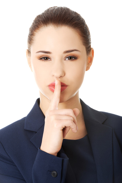 Businesswoman with finger on her lips - Photo, image