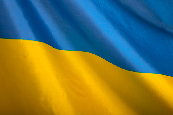 Flag of Ukraine. Blue and yellow colors. Close up shot, background - Foto, Imagem