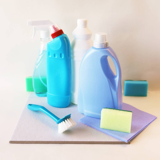 Płynne detergenty w plastikowych butelkach, domowe środki czyszczące na stole, lekkie tło, koncepcja czyszczenia, porządku, czystości, dostawa do domu - Zdjęcie, obraz
