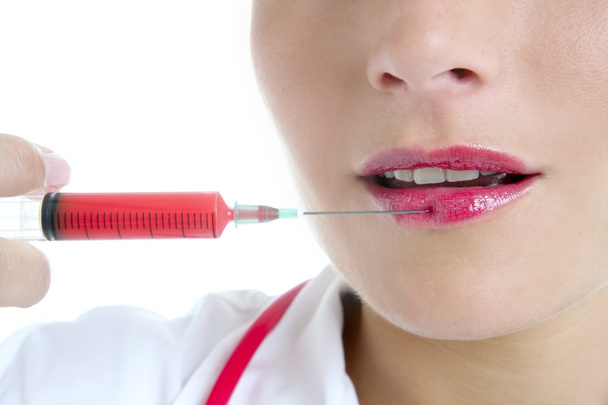 Doctor woman with red syringe in lips - Fotoğraf, Görsel