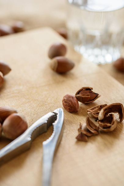 close-up of a bowl of delicious nuts on a wooden table - Fotoğraf, Görsel