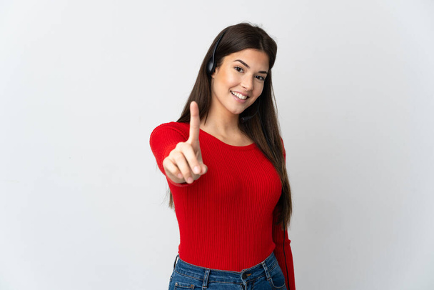 Young Brazilian telemarketer girl over isolated background showing and lifting a finger - Photo, Image